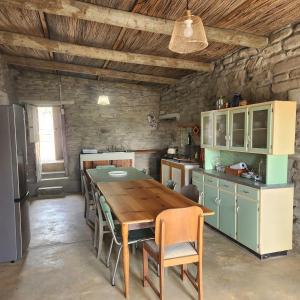 a kitchen with a wooden table in a room at From Valle Hideaway in Tankwa in Sutherland