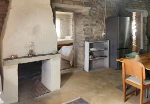 a living room with a fireplace and a refrigerator at From Valle Hideaway in Tankwa in Sutherland +8 photos