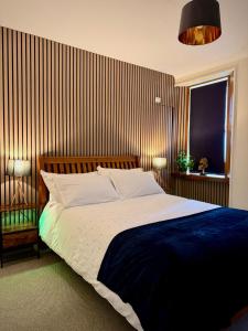a bedroom with a large bed and a window at Coorie in Inverness