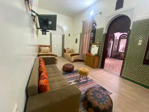 a living room with a couch and a tv at Dar Nassiri in Rabat +45 photos