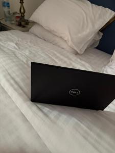 a laptop computer sitting on top of a bed at Nizalia resorts in Patriata