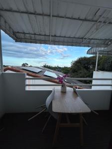 a table and chairs on a balcony with a view at My Dream Wedding in Nathon Bay