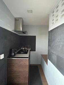 a small kitchen with a sink and a stove at My Dream Wedding in Nathon Bay