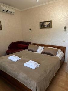 a bedroom with two beds with towels on them at Августин in Solochyn