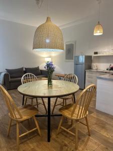 a table and chairs in a living room at Apocalypsis Houses in Skala