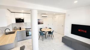 a kitchen and dining room with a table and chairs at Torrevieja - La Mata Beach First Line New Apartments 2024r in La Mata