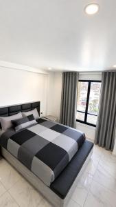 a bedroom with a large black and white bed at Torrevieja - La Mata Beach First Line New Apartments 2024r in La Mata +19 photos