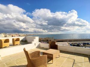 a balcony with chairs and a view of the ocean at Le Dimore del Canneto in Gallipoli