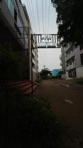 a sign that reads hotel good vibes in front of a building at Hotel good vibes in Coimbatore