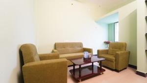 a waiting room with two chairs and a table at Hotel good vibes in Coimbatore