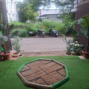a large iron bed in the grass in a garden at Hotel good vibes in Coimbatore