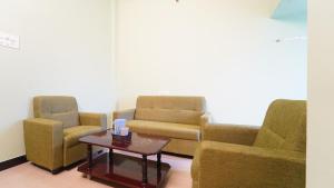 a waiting room with two chairs and a table at Hotel good vibes in Coimbatore