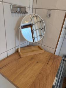 a mirror sitting on top of a wooden table at FeWo Susanne in Wiehl