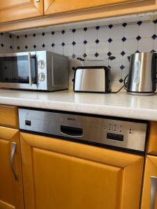 a kitchen with a microwave and a stove at FeWo Susanne in Wiehl +6 photos