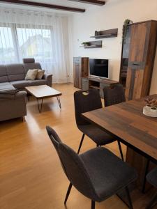 a living room with a table and a couch at FeWo Susanne in Wiehl