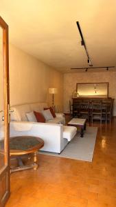 a bedroom with a white bed and a piano at Gredos Tiétar in El Arenal