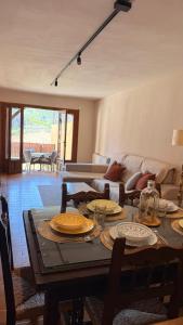 a living room with a table with plates on it at Gredos Tiétar in El Arenal