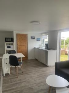 a kitchen and living room with a table and chairs at Apartment Frøya in Sætra