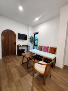 a living room with a bed and a table at baankorrakang in Bangkok Noi