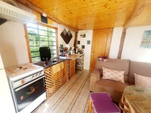 a kitchen and living room of a tiny house at Cortijo Saucillo in Albondón