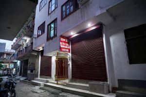a building with a large garage door on the side of it at Narayan Homestay & Guest House in Haridwār