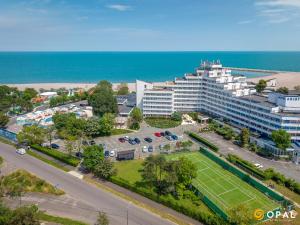 an aerial view of a hotel with a tennis court at Hotel Opal in Jupiter