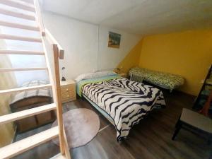 a small room with a bed and a ladder at Cortijo Saucillo in Albondón