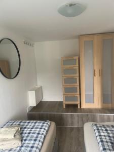a bedroom with two beds and a mirror at Apartment Frøya in Sætra