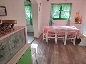a dining room with a table and a piano at Bakina iža in Duga Resa +105 photos
