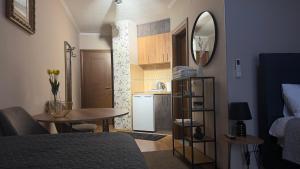 a bedroom with a bed and a table and a kitchen at Apartments Aleksandra Cetinje in Cetinje