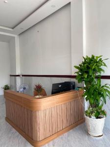 a lobby with a counter with potted plants at VyVy House Hotel in Tuy Hoa +15 photos
