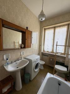a bathroom with a sink and a toilet and a sink at Appartamento Iris in Torre Pellice