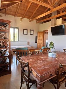 a dining room with a wooden table and chairs at Mia's Atelier in Kamária
