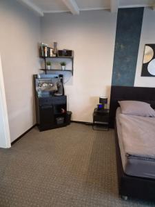 a bedroom with a bed and a tv in it at Zur schönen Aussicht in Langenfeld