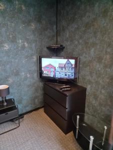 a television sitting on a dresser in a room at Zur schönen Aussicht in Langenfeld