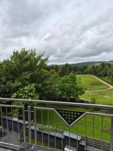 a view of a field from a balcony at Zur schönen Aussicht in Langenfeld