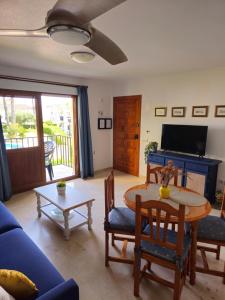 a living room with a table and a blue couch at Casa Indalo Vera Coast in Vera