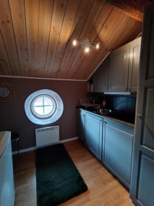 a kitchen with a small window in the ceiling at Jävregården in Jävre +5 photos