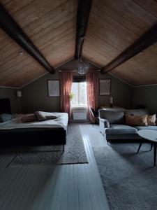 a bedroom with a bed and a couch and a table at Jävregården in Jävre