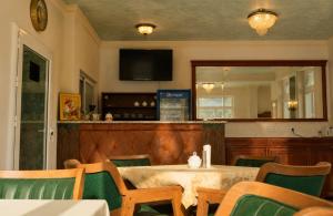 a dining room with a table and chairs and a mirror at Aleksov Complex Sans Souci in Ognyanovo