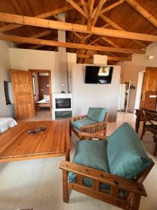 a living room with wooden furniture and a table at Mia's Atelier in Kamária +15 photos