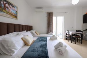 a bedroom with two beds with towels on them at Vila Enea in Ksamil