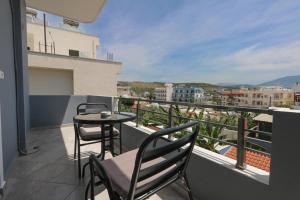 a balcony with a table and chairs and a view at Vila Enea in Ksamil