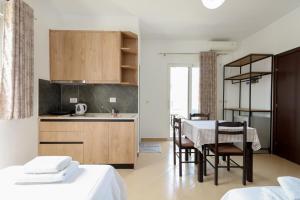a kitchen and dining room with a table and chairs at Vila Enea in Ksamil