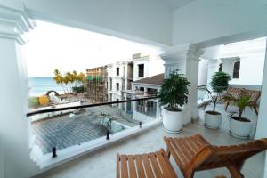 a balcony with chairs and a view of the ocean at PSR Coral Resorts, 800m Away from Rameswaram Temple in Rāmeswaram
