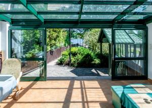 a glass house with a view of a garden at Willa Sarenka in Radzyń +17 photos