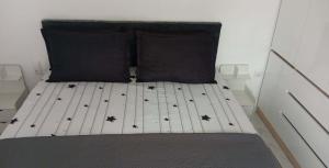 a bed with black spiders on it in a room at Apartman Ema in Bihać
