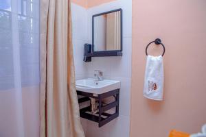 a bathroom with a sink and a mirror at Kiliheights Getaway in Sanya Chini Station +44 photos