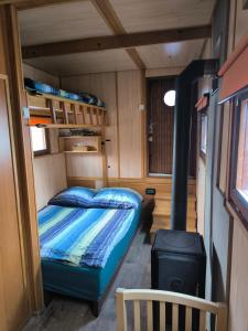 a bedroom with a bed and a stove in a rv at Hausbót Slapy in Dublovice