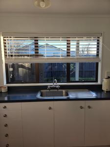 a kitchen with a sink and a window at Changing Seasons in Cambridge